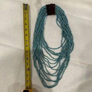 Beaded necklace with wooden clasp